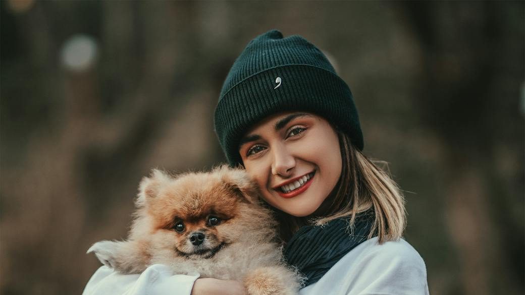 shallow focus photo of woman carrying her dog